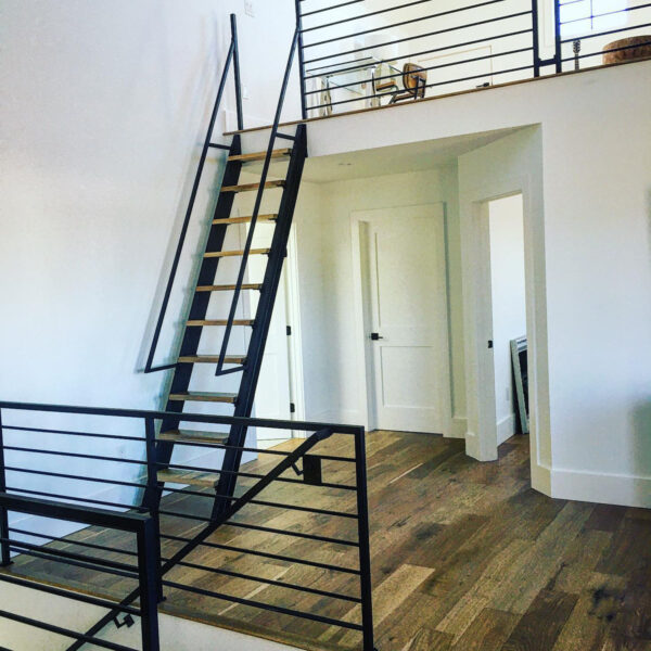 Tri-Level Living Areas Showcasing Black Steel Partition Walls and Black Steel Loft Ladder With Hand Railings