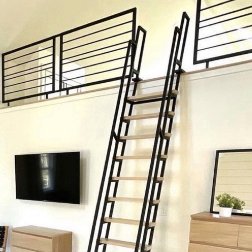 Black loft ladder with blonde wooden stairs and black loft railings